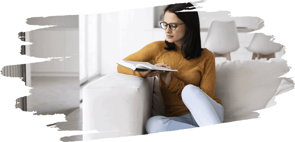 young woman reading from book home 1